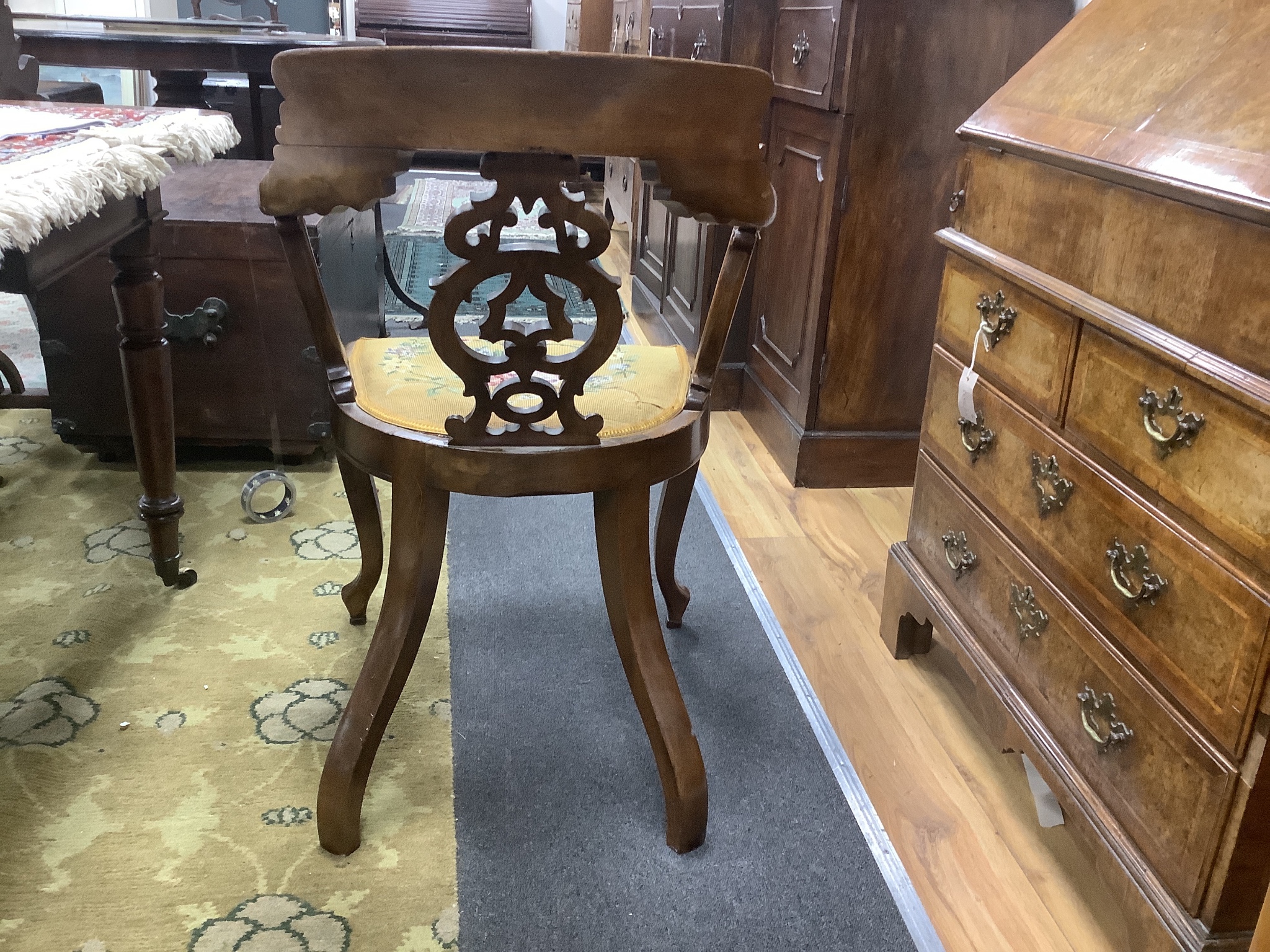 A Victorian carved walnut elbow chair, width 58cm, depth 48cm, height 90cm